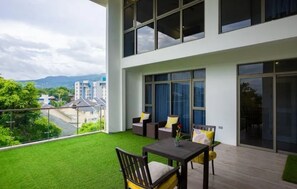 Eine moderne Wohnung mit Balkon, Essbereich und großen Fenstern.