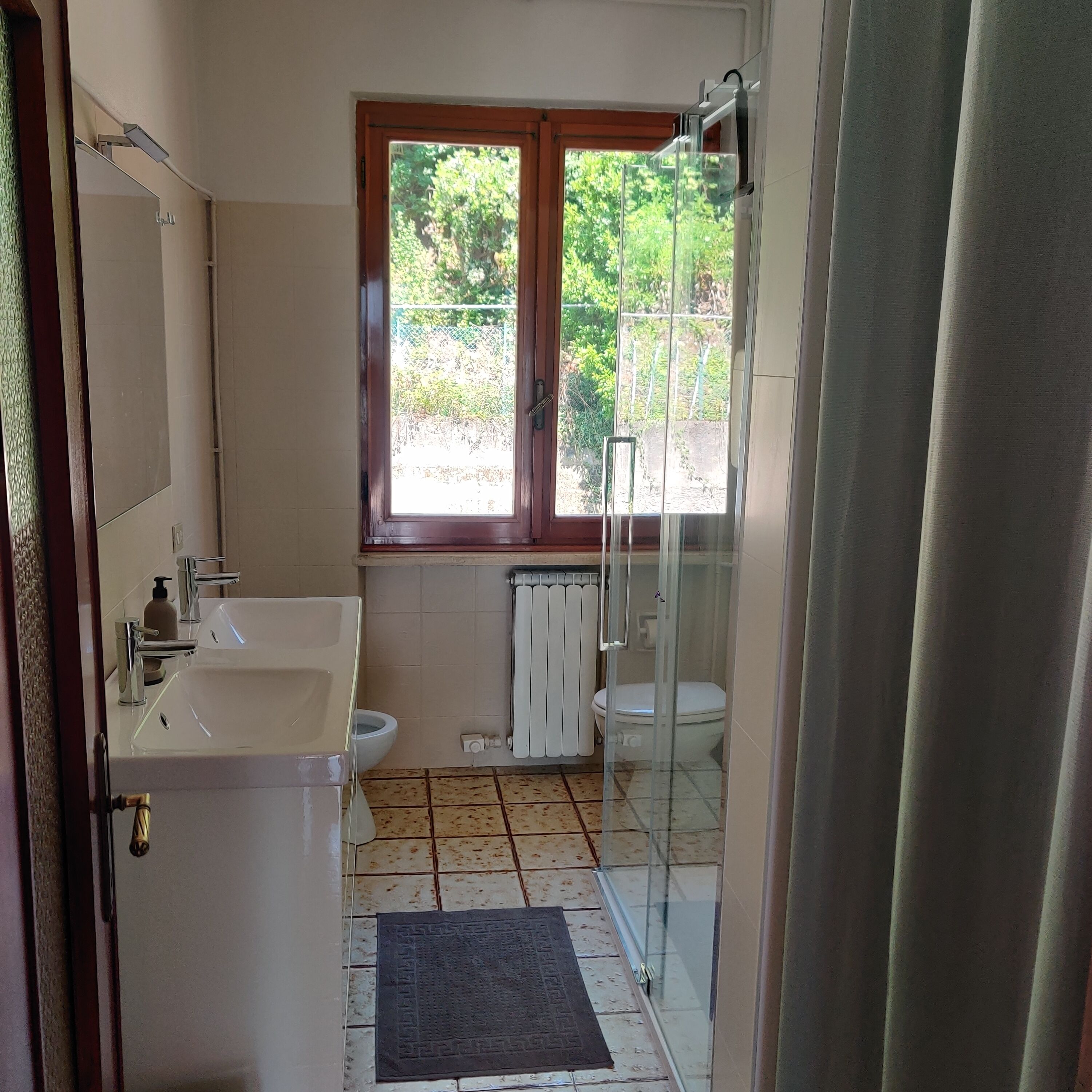 A bathroom with a sink, toilet, and shower.