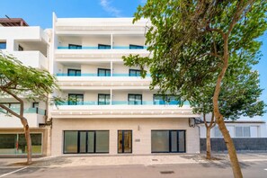 A multi-story hotel with a flat facade, large windows, and a gated entrance. - Ereza Residence 5 - Two Bedroom Apartment, Sleeps 4 (Arrecife)