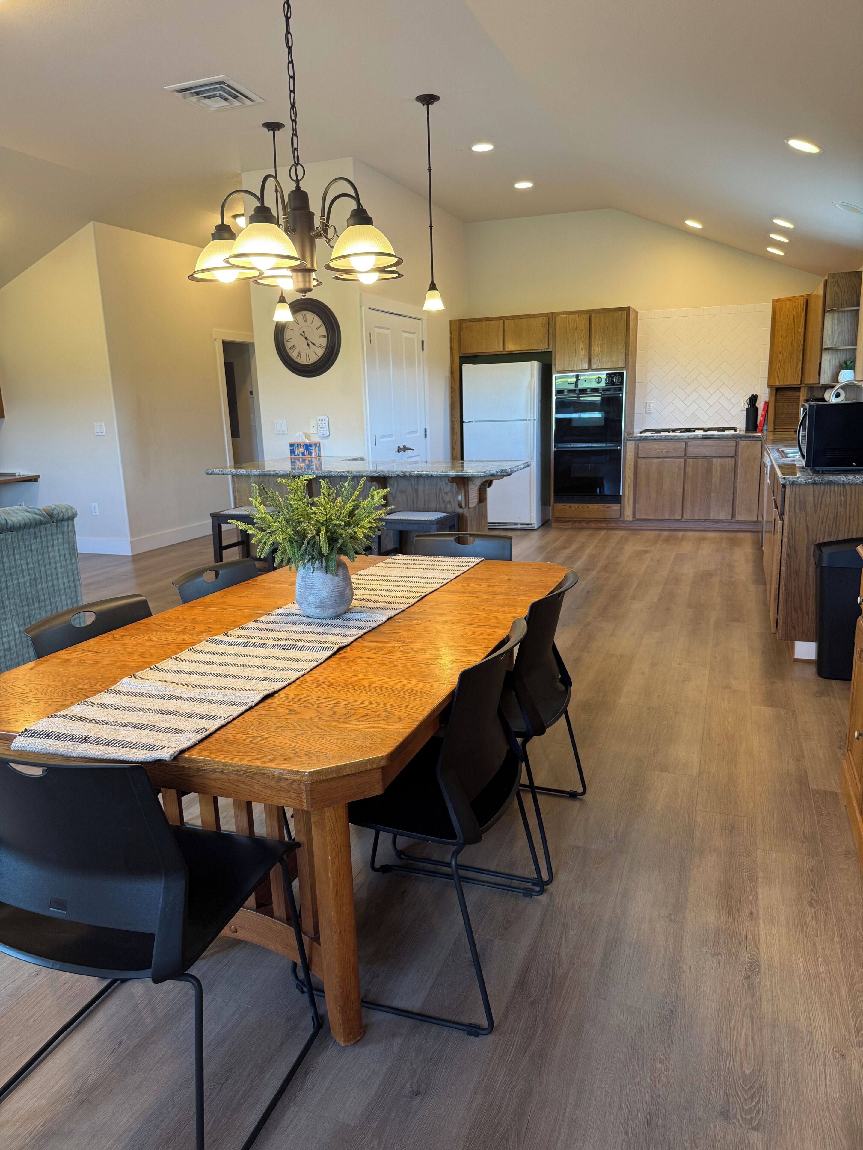 A modern kitchen with wooden cabinets, a built-in oven, and a refrigerator.