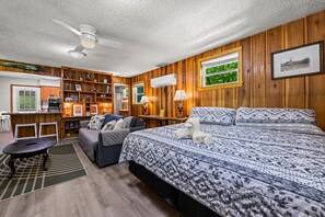 A room with a bed, a sofa, a desk, and a ceiling fan. - Nantahala Ridge (Bryson City)