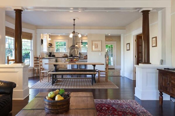 A spacious kitchen with a central island, wooden furniture, and a large window. - Cascade Chic 30 day minimum (Hood River)