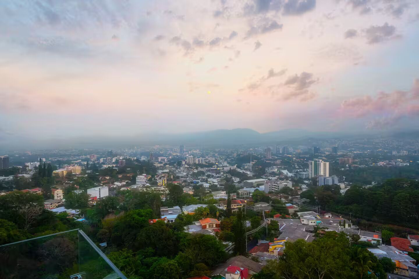A cityscape with buildings, roads, and greenery.