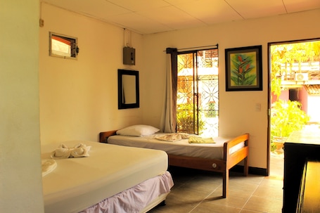 A room with two beds, a window with curtains, a framed picture, and a small table.. Landing Hotel