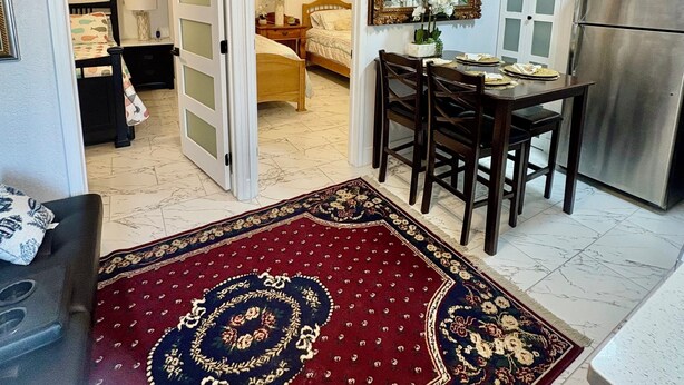 A room with a bed, a dining table with chairs, a kitchen area with a refrigerator, and a ceiling fan. - and welcoming.
Carrollwood Paradise
 2BR Apartment Central Tampa Near Everything (Tampa)