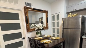 A dining area with a table set for four, a refrigerator, and a mirror on the wall. - and welcoming.
Carrollwood Paradise
 2BR Apartment Central Tampa Near Everything (Tampa)