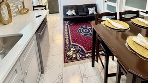 A modern kitchen with a dining area, a ceiling fan, and a TV mounted on the wall. - and welcoming.
Carrollwood Paradise
 2BR Apartment Central Tampa Near Everything (Tampa)