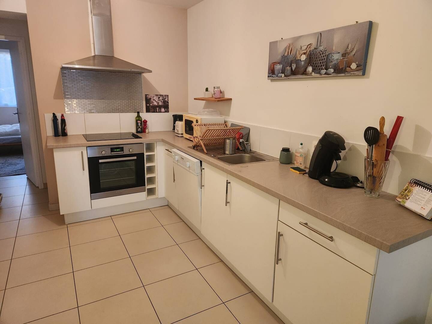 A modern kitchen with a stove, oven, microwave, and a sink.