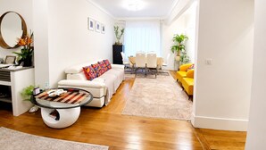 A modern living room with a sofa, coffee table, dining table, and chairs. - Paris 16 Michelangelo. Les Beaux Quartiers de Paris (Paris)