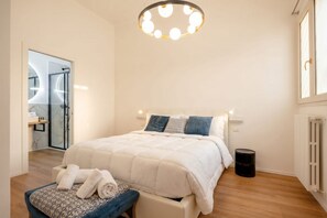 A bedroom with a bed, bedside table, and a circular ceiling light fixture. - Maison Manzoni - Contemporary Elegance (Bari)