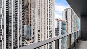 A high-rise building with multiple floors, large windows, and a balcony. - 501 First #2506 Skyline Essence Living (Miami)