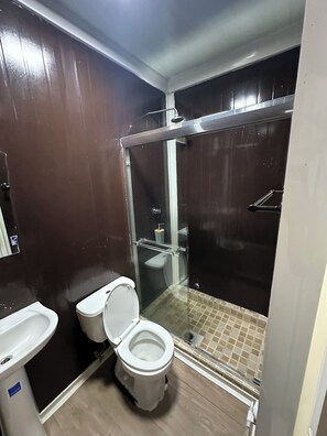 A bathroom with a toilet, bidet, and a glass-enclosed shower stall. - La Macana Ecotour (Cacique)