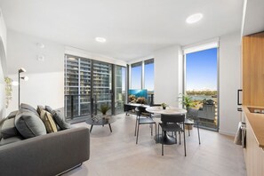 A modern apartment with a balcony, a dining area, and a view of the city. - Miami Skyline Family Residence 501 First #2012 (Miami)