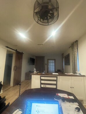 A dining area with a table, chairs, a ceiling fan, and a kitchen in the background. - Chamblee Station Luxury Suite , Direct MARTA to Mercedes-Benz (Atlanta)