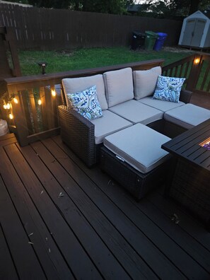 A deck with a sectional sofa, wicker chairs, and a small table. - River City Retreat •Hot Tub •Game Room• Sleeps 8 Near Fort Benning (Columbus)
