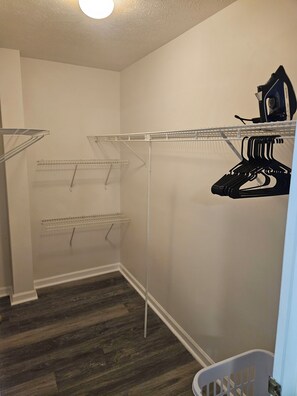 A laundry room with metal shelves, a drying rack, and a laundry basket. - River City Retreat •Hot Tub •Game Room• Sleeps 8 Near Fort Benning (Columbus)