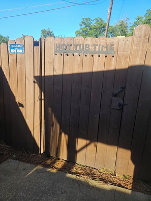 A wooden gate with a sign that reads 'HOT TUB TIME.' - River City Retreat •Hot Tub •Game Room• Sleeps 8 Near Fort Benning (Columbus)