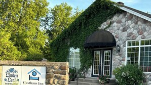 A stone building with a sign for 'Linden Leaf Restaurant' and 'Gasthaus Inn.' - Linden Leaf Gasthaus Inn Apartment Pet friendly Country walks, just off hwy 416 (Oxford Station)