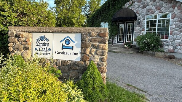 A stone building with a sign for Linden Leaf Restaurant and Gasthaus Inn. - Linden Leaf Gasthaus Inn Apartment Pet friendly Country walks, just off hwy 416 (Oxford Station)