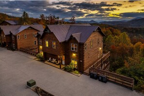 Mountain cabin community view at sunset with rustic lodges, scenic hillsides, and peaceful Smoky Mountain atmosphere. - Smoky Mountain 13BR Lodge | Pool & Hot Tub | Sleeps 58 (Sevierville)