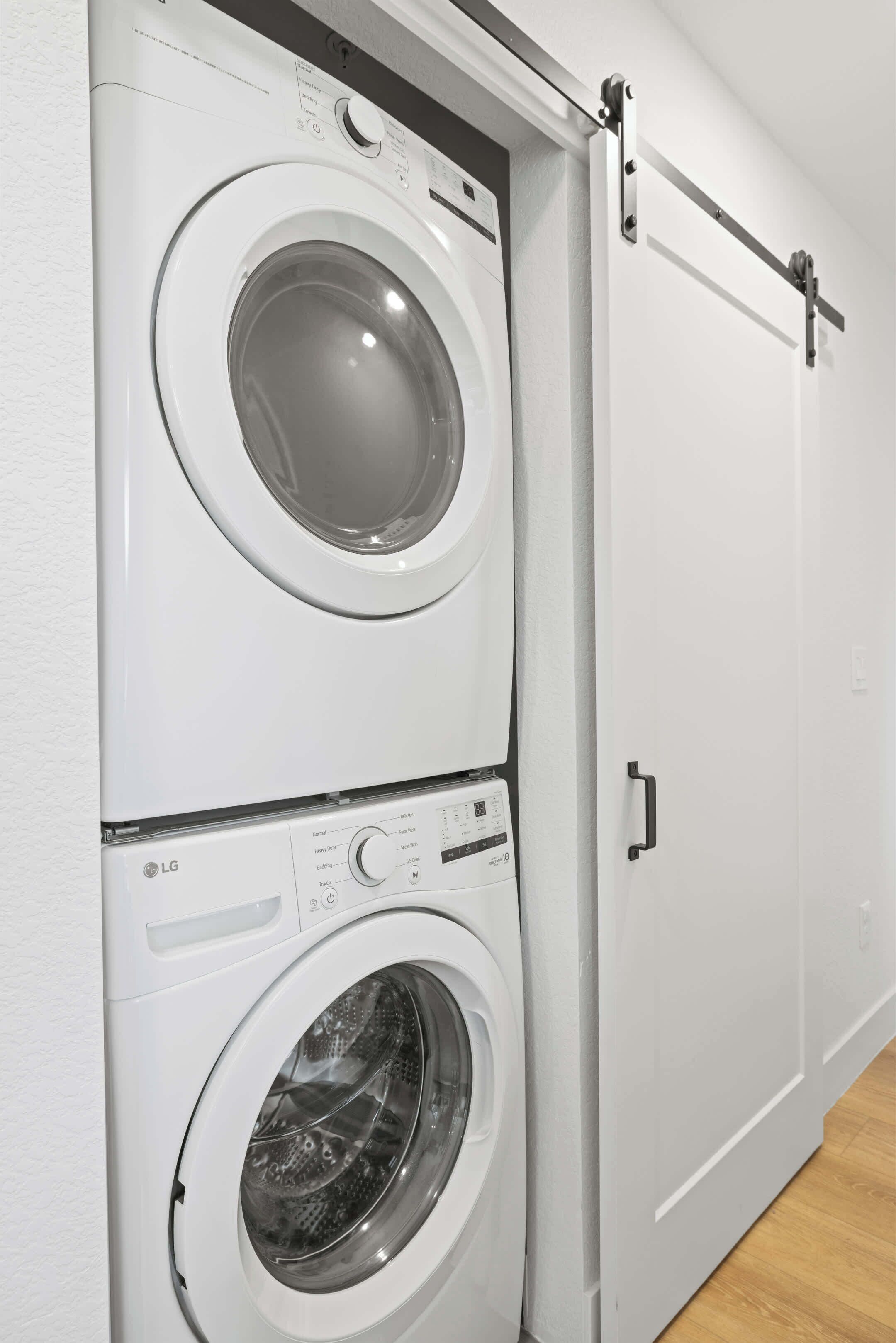 A wall-mounted laundry machine with a control panel and a door.