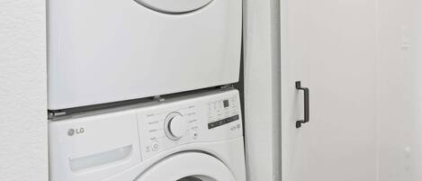 A wall-mounted laundry machine with a control panel and a door.
