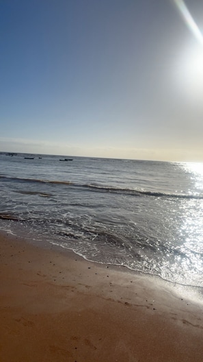 Ein Strand mit Sand und Wasser.