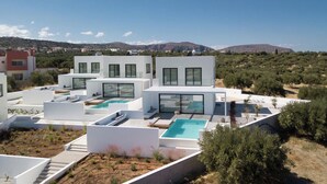 A modern villa with multiple swimming pools, a rooftop terrace, and a view of the surrounding landscape. - Luxury 2BR Cretan Villa Near Hersonissos Beaches (Hersonissos)