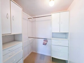 A walk-in closet with white cabinetry, a hanging rod, and a small towel rack. - Breezy Cove-Spacious, Gulf Access, Near Beaches (Apollo Beach)