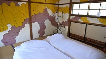 Een kamer met een bed, een raam met uitzicht en een wand met een patroon.