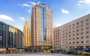 A high-rise hotel with multiple floors, a glass facade, and a modern architectural design.