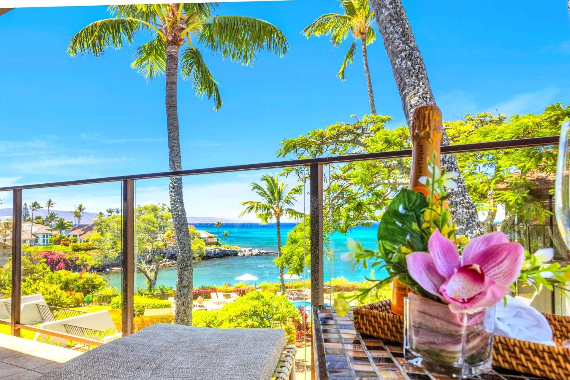 A balcony with a view of a tropical beach and ocean.