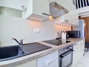 A modern kitchen with a stainless steel sink, a built-in oven, and a microwave. - Ortal Océan by Interhome (Lacanau)