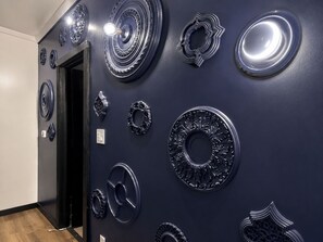 A wall with various circular metallic wall decorations.