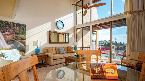 A spacious living area with a glass table, a sofa, and a view of the outdoors. - Napili Point 3 Water Front Villas, Sleeps 18 | Car Incl. w/ 6 nights | ML-4086 by KBM (Lahaina)