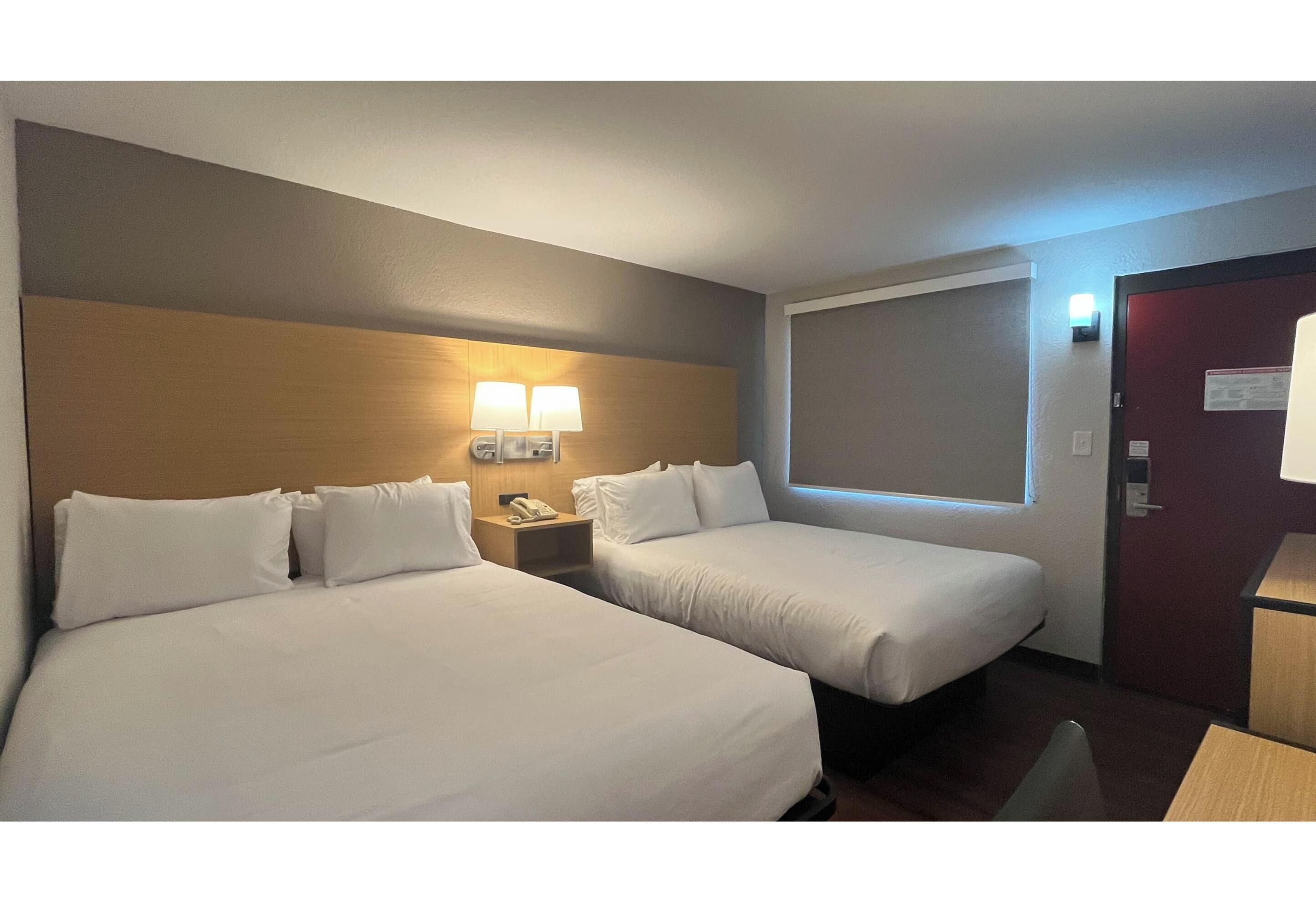 Premium bedding, desk, laptop workspace, blackout curtains