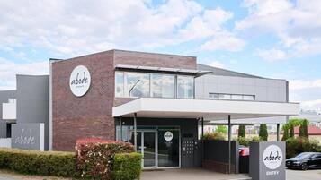 A modern building with a sign reading 'abode' and an 'ENTRY' sign.