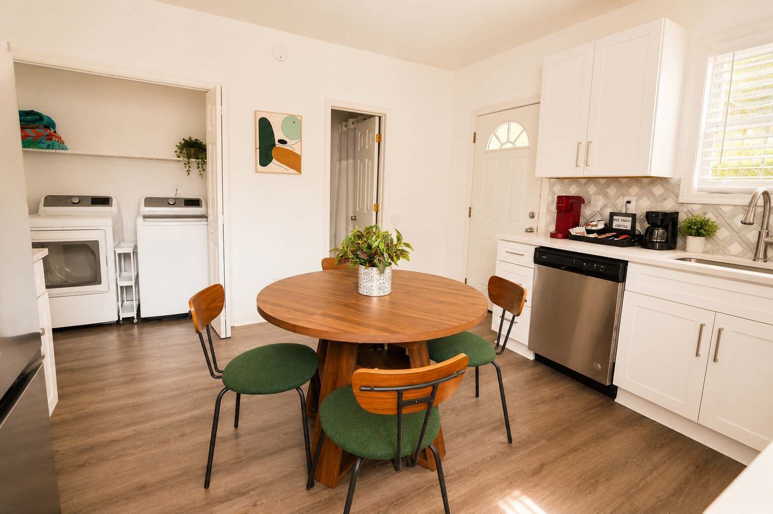 A compact kitchen with a dishwasher, a coffee maker, and a sink.