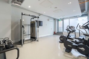 A gym with cardio machines, free weights, and a weight machine. - Student Only Livin (Cardiff)