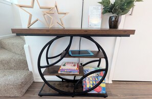 A wooden shelf with a star decoration, a welcome sign, and a potted plant.