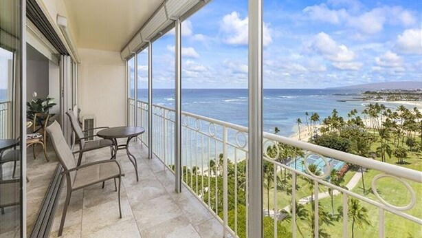 A balcony with a view of the ocean and a pool. - Oceanfront Paradise 1Bdrm at the Waikiki Shore (Honolulu)