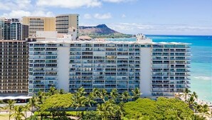A high-rise hotel with multiple floors, a beach view, and a mountain in the background. - Oceanfront Paradise 1Bdrm at the Waikiki Shore (Honolulu)