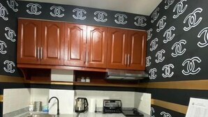 A kitchen with wooden cabinets, a countertop, and a sink.