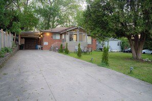 A two-story house with a garage, a covered porch, and a small lawn. - Spacious 5 bedroom Niagara Falls retreat. Minutes to USA Canada cross border! (Niagara Falls)