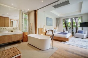 A modern bedroom with a large bathtub, a bed with a view, a sofa, and a TV. - Trichada Villa 4 Luxury Residences (Thalang)