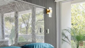 A modern bedroom with a large bed, a window with a view of trees, and a potted plant. - Massive rooftop terrace steps from everything (Mexico City)