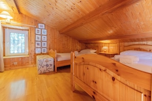 A wooden cabin with two beds, a bench, a window, and framed pictures on the wall. - Bel'Alp 24 Historical Residence Near Ski Lifts at Le Tour in Chamonix, Le Tour (Argentière), France (Le Tour (Argentière))