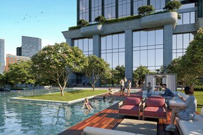 A modern building with a pool, outdoor seating, and greenery. - Marqen Hotel (Jakarta)