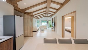 A modern interior with a kitchen, dining area, and living room. - Pocheon New Dream Pension (Pocheon)