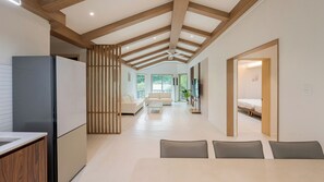 A modern interior with a kitchen, dining area, and living room.